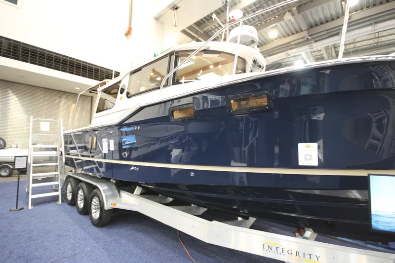 The Image of 2027 Ranger Tugs R-27 boat on display in an indoor showroom. - 0