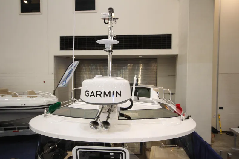 Slide: The Image of 2026 Ranger Tugs R-27 boat with Garmin navigation system on display indoors. - 28