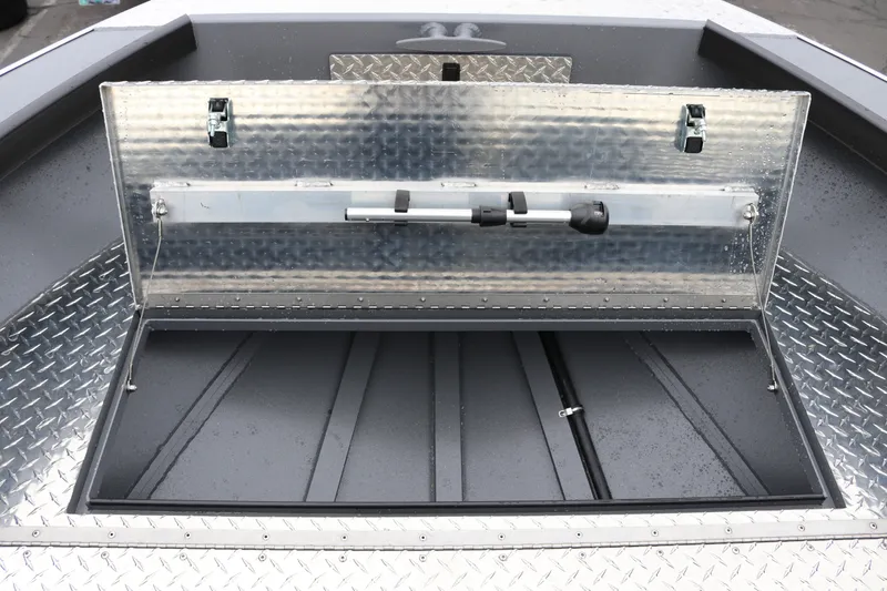 Slide: The Image of Alumaweld Super Vee Pro 23 boat storage compartment, open with diamond plate detailing, 2027 model. - 9