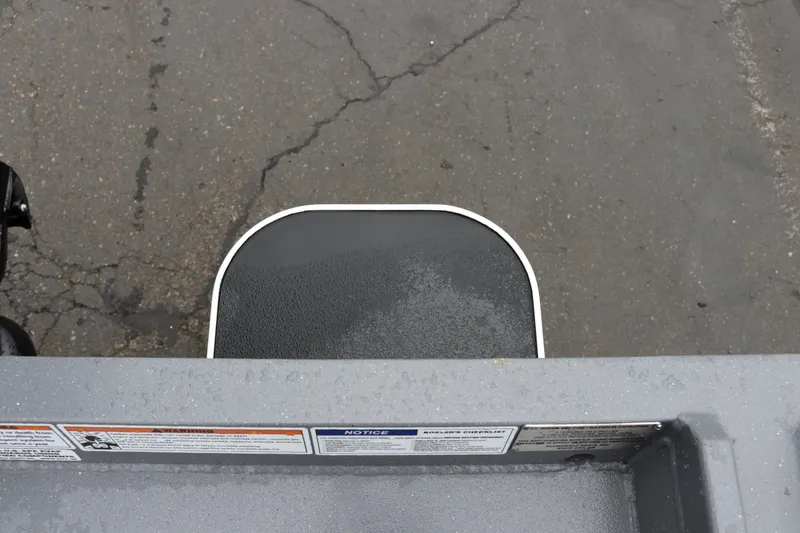 Slide: The Image of Alumaweld Super Vee Pro 23 boat step detail, 2027 model, on wet pavement. - 27
