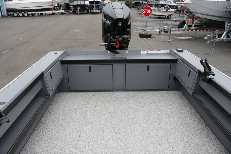 Slide: The Image of 2027 Alumaweld Super Vee Pro 23 boat interior with Mercury outboard motor in a marina. - 17