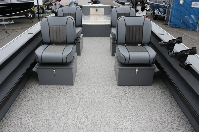 Slide: The Image of 2027 Alumaweld Super Vee Pro 23 boat interior with four gray seats and rod holders. - 12