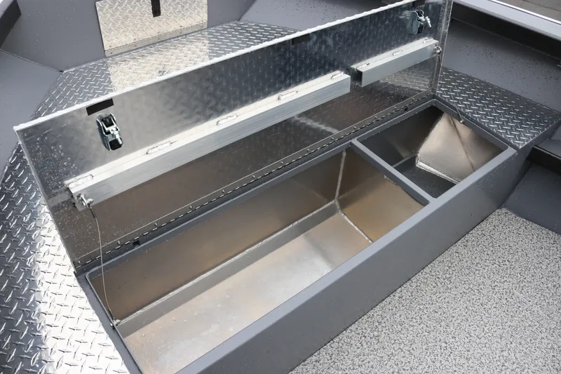 Slide: The Image of Open storage compartment in 2027 Alumaweld Super Vee Pro 23 boat, featuring diamond plate flooring. - 11