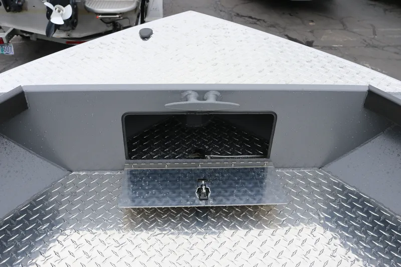 Slide: The Image of 2027 Alumaweld Super Vee Pro 23 boat deck with diamond plate finish and storage compartment. - 8