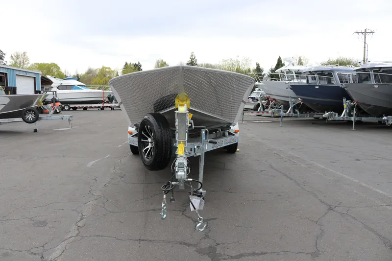 Slide: The Image of 2027 Alumaweld Super Vee Pro 23 boat on trailer in a parking lot. - 2