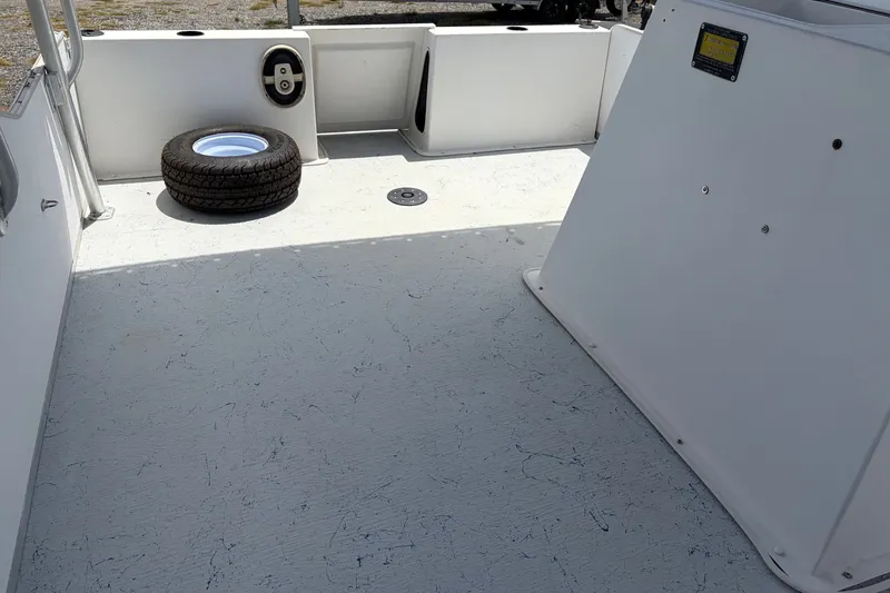 Slide: The Image of 1998 Beachcat 19 boat interior with spare tire on deck. - 11