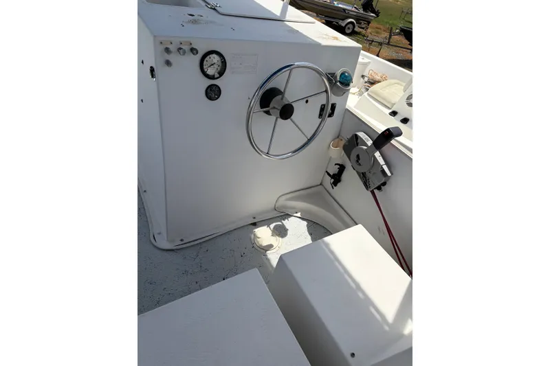 Slide: The Image of Steering console of a 1998 Beachcat 19 boat with gauges and controls. - 10