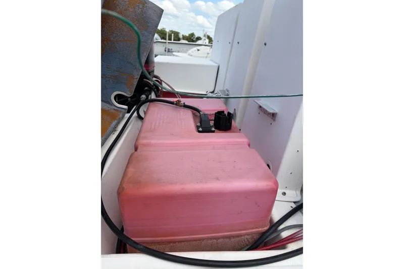 Slide: The Image of Red fuel tank in a 1998 Beachcat 19 boat, surrounded by cables and equipment. - 3