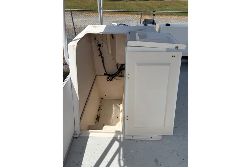 Slide: The Image of 1998 Beachcat 19 boat storage compartment with open door, showing interior wiring. - 8