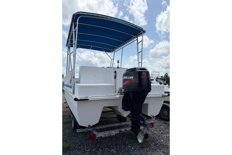 Slide: The Image of 1998 Beachcat 19 boat with Mercury 75 outboard motor and blue canopy. - 2