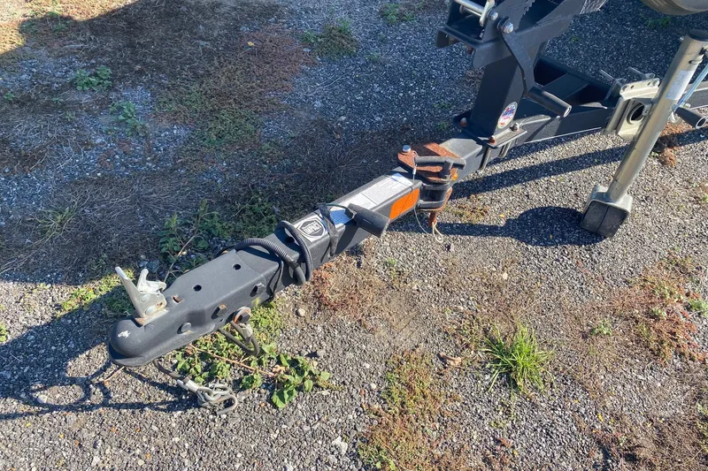 Slide: The Image of Trailer hitch of a 2018 Bass Tracker Pro 19 on gravel surface. - 11