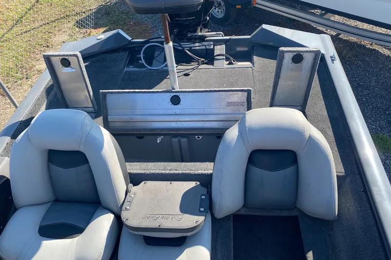 Slide: The Image of 2018 Bass Tracker Pro 19 boat interior with seating and storage compartments. - 7
