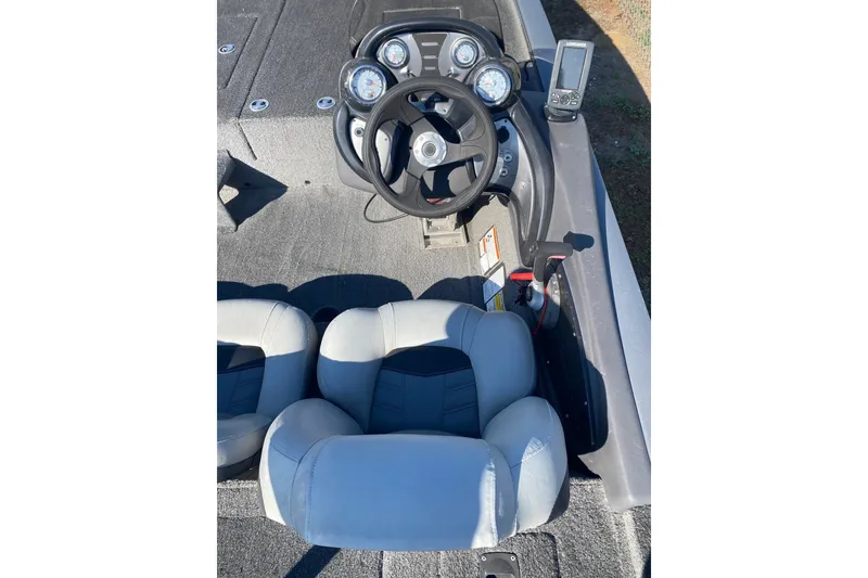 Slide: The Image of 2018 Bass Tracker Pro 19 boat cockpit with steering wheel and gauges. - 6