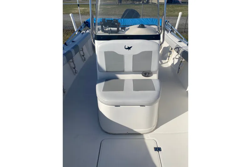 Slide: The Image of 2018 Mako 204 Center Console boat interior with cushioned seating and steering console. - 6