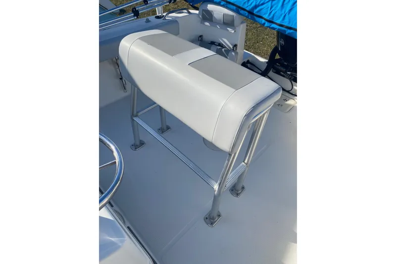 Slide: The Image of 2018 Mako 204 Center Console boat interior with white seating and stainless steel frame. - 10