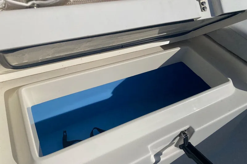 Slide: The Image of Open storage compartment on a 2018 Mako 204 Center Console boat. - 4