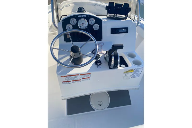 Slide: The Image of Steering console of 2018 Mako 204 Center Console boat with gauges and controls. - 9