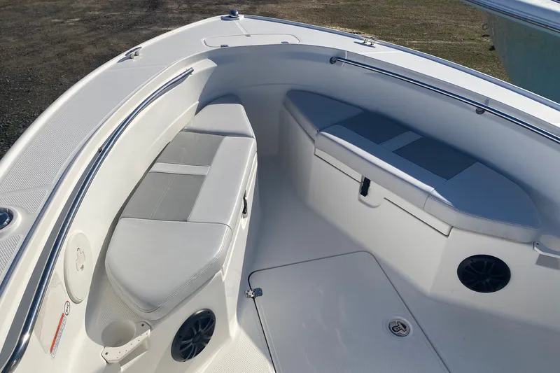 Slide: The Image of 2018 Mako 204 Center Console boat interior with cushioned seating and storage compartments. - 3