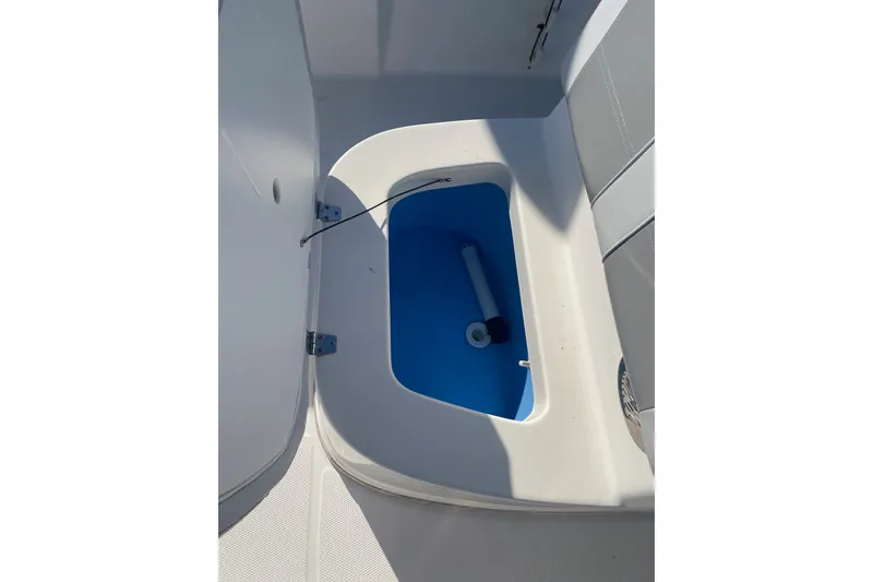 Slide: The Image of Open storage compartment on 2018 Mako 204 Center Console boat. - 7