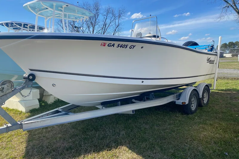 The Image of 2018 Mako 204 Center Console boat on trailer, parked on grass. - 1