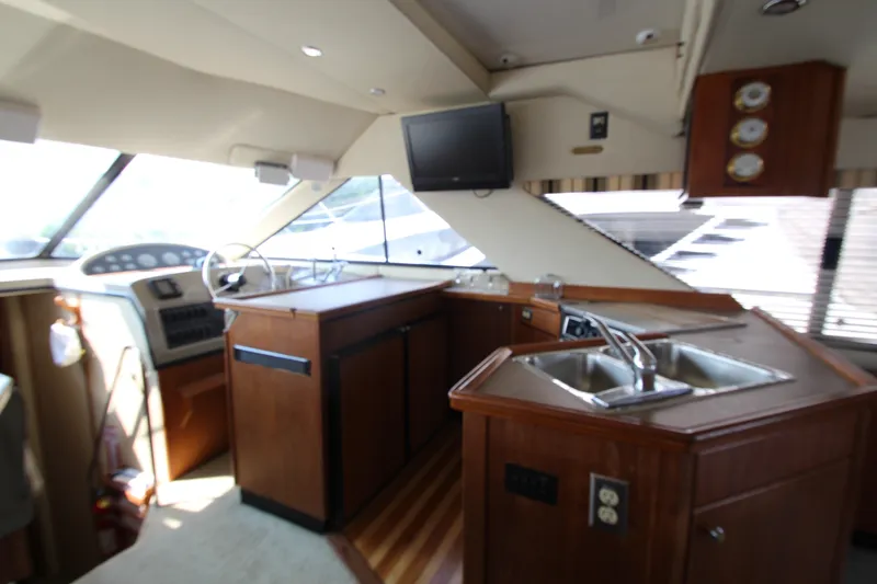 Slide: The Image of Interior of 1996 Bayliner 3988 Command Bridge Motoryacht with helm and kitchen area. - 24