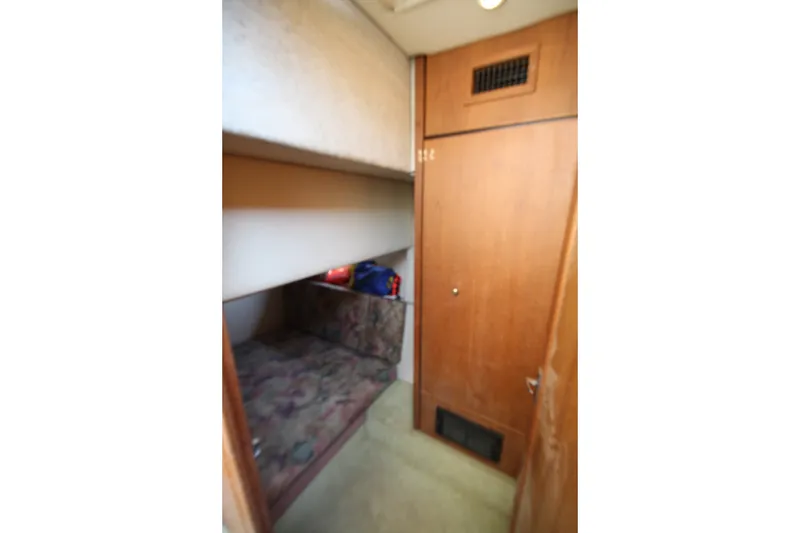 Slide: The Image of Interior cabin of 1996 Bayliner 3988 Command Bridge Motoryacht with bunk beds and wooden door. - 33