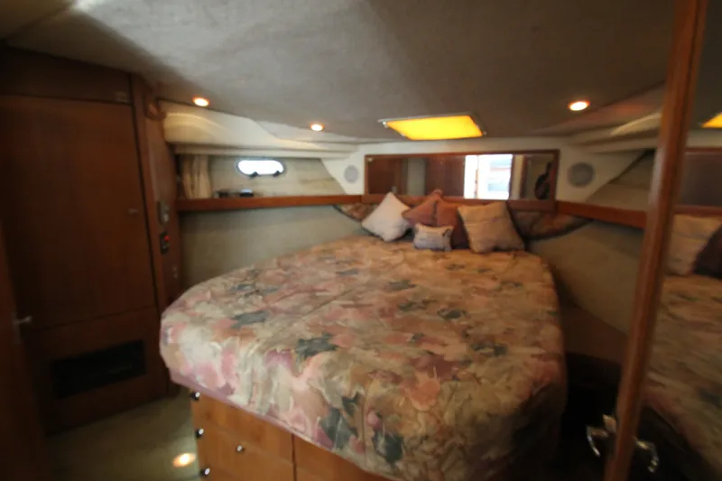 Slide: The Image of Cozy bedroom in 1996 Bayliner 3988 Command Bridge Motoryacht with floral bedding and wood accents. - 46