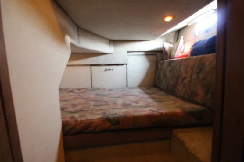 Slide: The Image of Cozy cabin interior of 1996 Bayliner 3988 Command Bridge Motoryacht with floral-patterned bedding. - 36