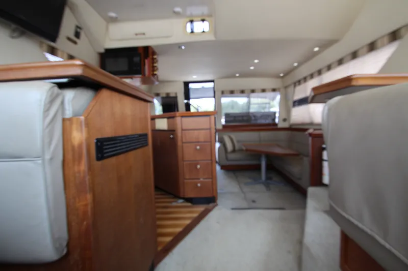 Slide: The Image of Interior of 1996 Bayliner 3988 Command Bridge Motoryacht with wood accents and seating area. - 31