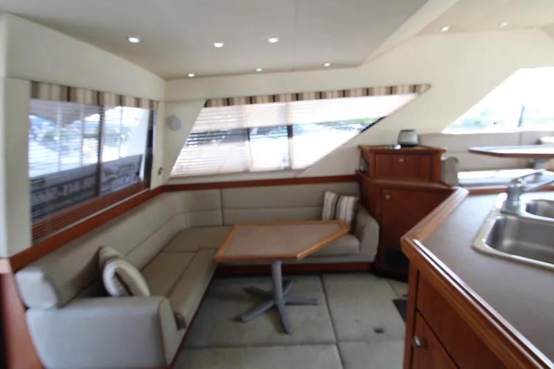 Slide: The Image of Interior of 1996 Bayliner 3988 Command Bridge Motoryacht with seating and dining area. - 21