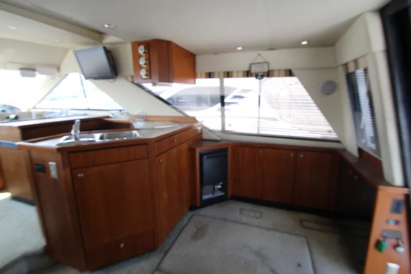 Slide: The Image of Interior of 1996 Bayliner 3988 Command Bridge Motoryacht with wooden cabinetry and sink. - 22