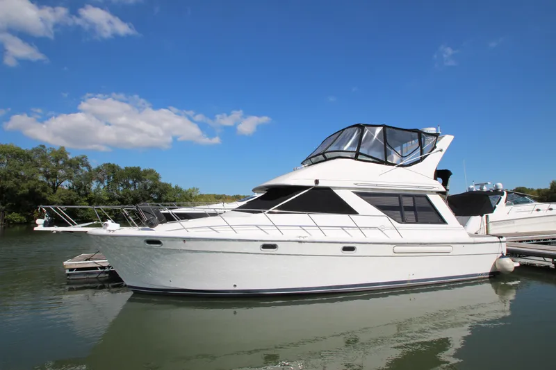 Slide: The Image of 1996 Bayliner 3988 Command Bridge Motoryacht docked on a sunny day. - 3
