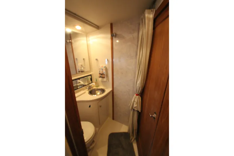 Slide: The Image of Bathroom interior of 1996 Bayliner 3988 Command Bridge Motoryacht, featuring sink and toilet. - 37