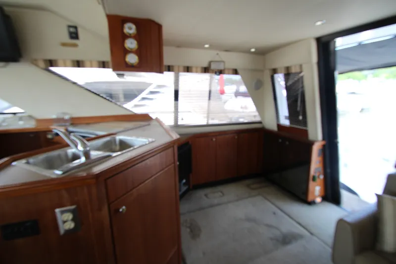 Slide: The Image of Interior of 1996 Bayliner 3988 Command Bridge Motoryacht with wood cabinetry and dual sinks. - 26