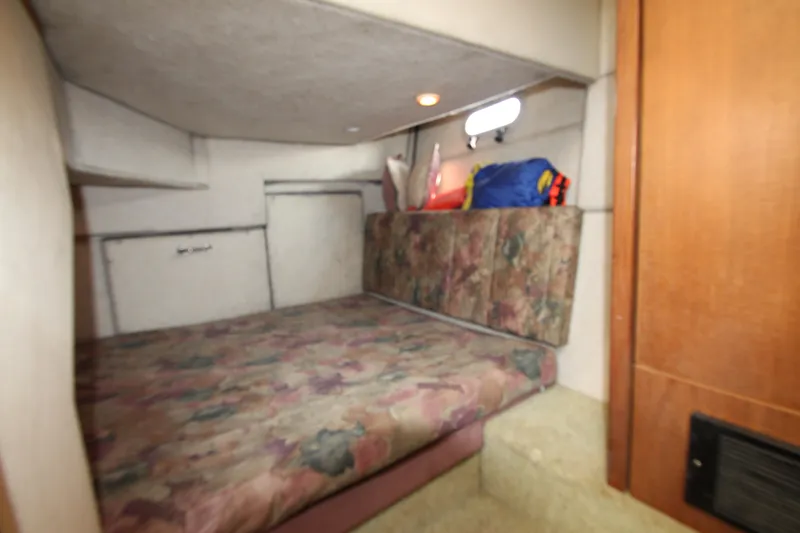Slide: The Image of Cozy cabin interior of 1996 Bayliner 3988 Command Bridge Motoryacht with floral upholstery. - 34