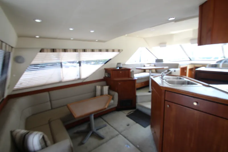 Slide: The Image of Interior of 1996 Bayliner 3988 Command Bridge Motoryacht with seating and kitchen area. - 20