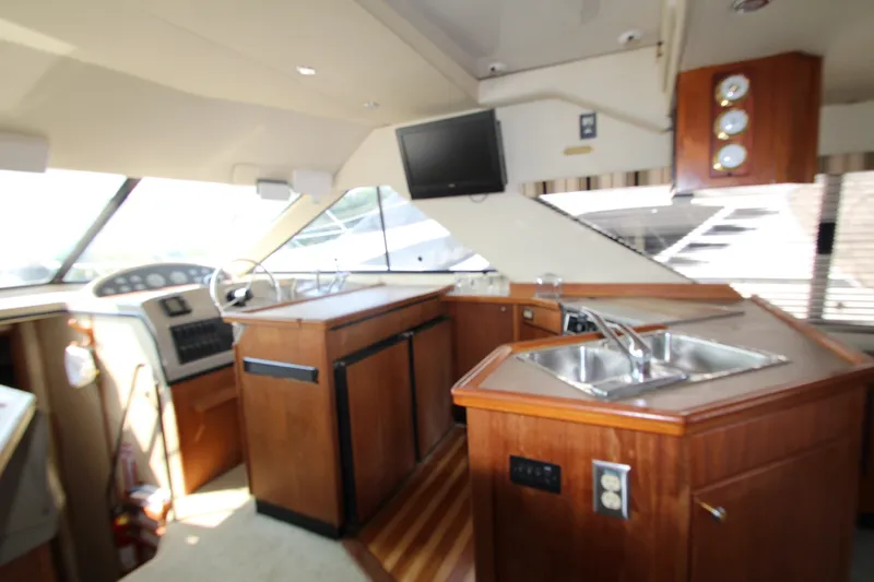 Slide: The Image of Interior of 1996 Bayliner 3988 Command Bridge Motoryacht with helm and kitchen area. - 25