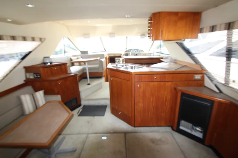 Slide: The Image of Interior of 1996 Bayliner 3988 Command Bridge Motoryacht with wood cabinetry and seating area. - 17