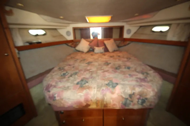 Slide: The Image of Cozy bedroom interior of 1996 Bayliner 3988 Command Bridge Motoryacht with floral bedding. - 51