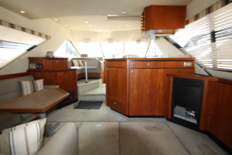 Slide: The Image of Interior of 1996 Bayliner 3988 Command Bridge Motoryacht with wood cabinetry and seating area. - 18