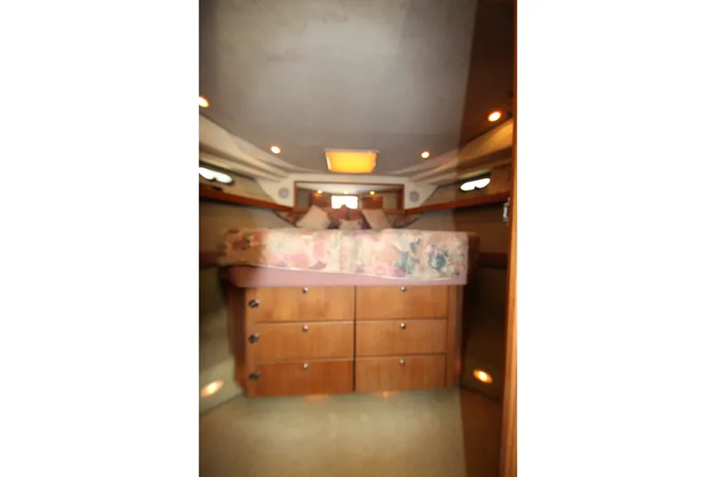 Slide: The Image of 1996 Bayliner 3988 Command Bridge Motoryacht interior cabin with bed and storage drawers. - 41