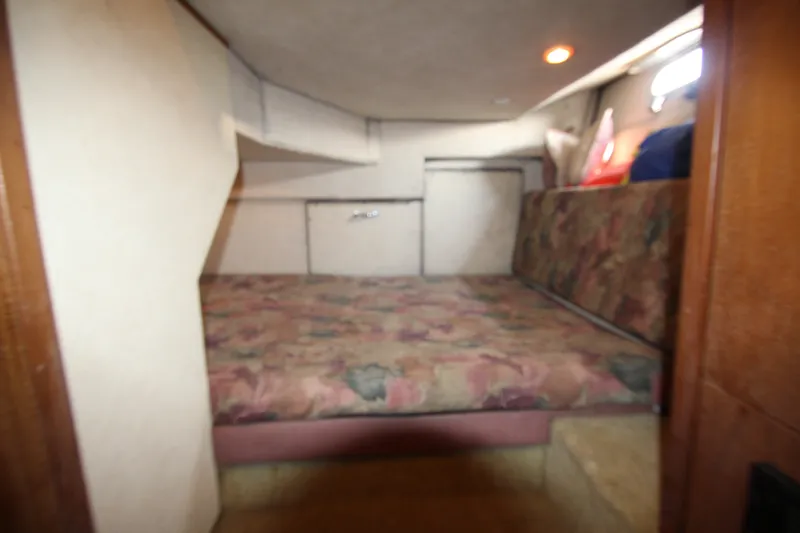 Slide: The Image of Interior cabin of 1996 Bayliner 3988 Command Bridge Motoryacht with floral-patterned bedding. - 35