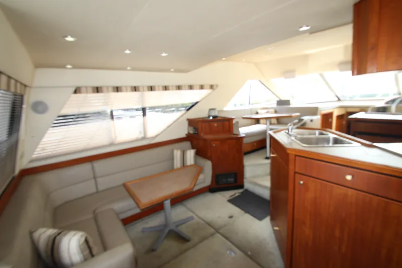 Slide: The Image of Interior of 1996 Bayliner 3988 Command Bridge Motoryacht with seating, table, and kitchenette. - 19