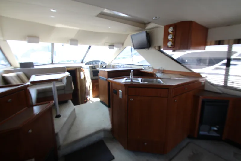 Slide: The Image of Interior of 1996 Bayliner 3988 Command Bridge Motoryacht with kitchen and seating area. - 23
