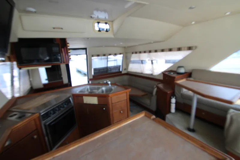 Slide: The Image of Interior of 1996 Bayliner 3988 Command Bridge Motoryacht with kitchen and seating area. - 29
