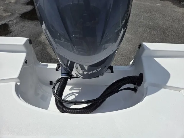 Slide: The Image of A 2020 Sportsman Masters 247 Bay Boat with an outboard motor on a white deck. - 28