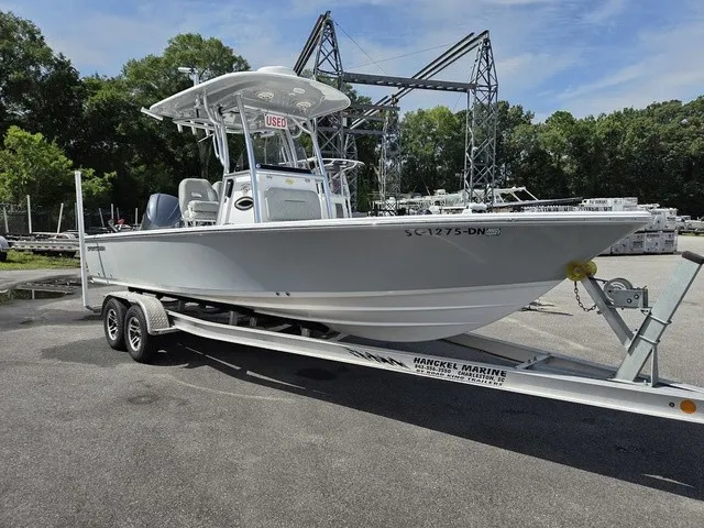 Slide: The Image of A gray 2020 Sportsman Masters 247 Bay Boat on a trailer in a marina area. - 2