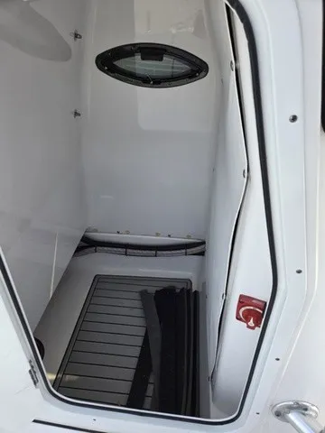 Slide: The Image of Interior of a 2020 Sportsman Masters 247 Bay Boat with an oval window and flooring. - 16