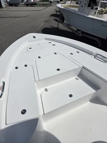 Slide: The Image of The image shows the bow deck of a 2020 Sportsman Masters 247 Bay Boat with storage hatches. - 9