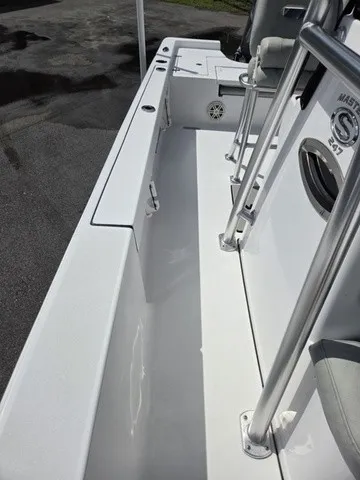 Slide: The Image of The image shows the deck of a 2020 Sportsman Masters 247 Bay Boat with white surfaces. - 14